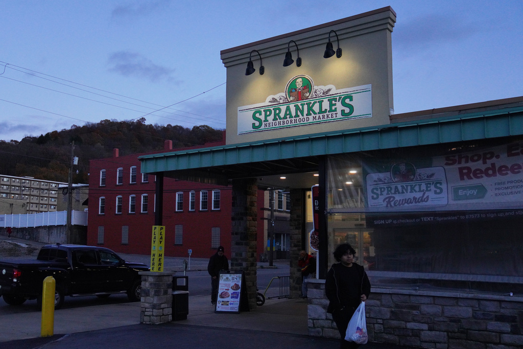 People leave Sprankle's Neighborhood Market, Monday, Nov. 10, 2025, in Kittanning, Pa. (AP Photo/Jessie Wardarski)
