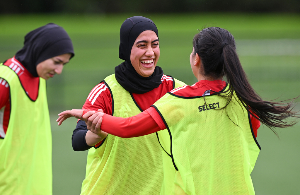 Afghan women's soccer player Khursand Azizi, center, reacts with teammates during a training session in Auckland, New Zealand, Tuesday, June 2, 2026. (Andrew Cornaga/Photosport via AP)