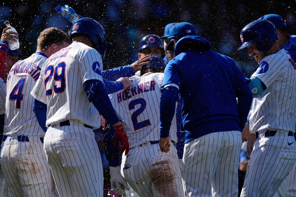 Chicago Cubs' Nico Hoerner (2) celebrates with teammates after hitting a sacrifice fly to New York Mets right fielder Tyrone Taylor during the 10th inning of a baseball game in Chicago, Sunday, April 19, 2026. (AP Photo/Nam Y. Huh)