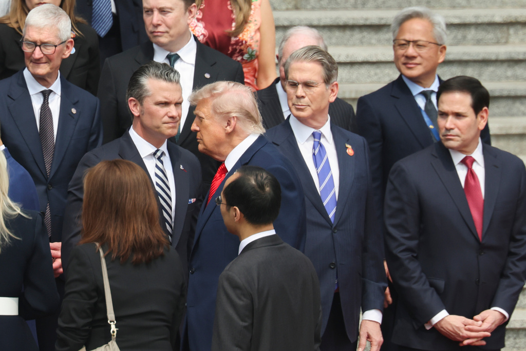 U.S. President Donald Trump looks on next to, from bottom right, U.S. Secretary of State Marco Rubio, U.S. Treasury Secretary Scott Bessent, U.S. Defense Secretary Pete Hegseth, Nvidia CEO Jensen Huang, top right, Tesla CEO Elon Musk, Apple CEO Tim Cook, top left, and others during a welcome ceremony at the Great Hall of the People in Beijing, Thursday, May 14, 2026. (Maxim Shemetov/Pool Photo via AP)
