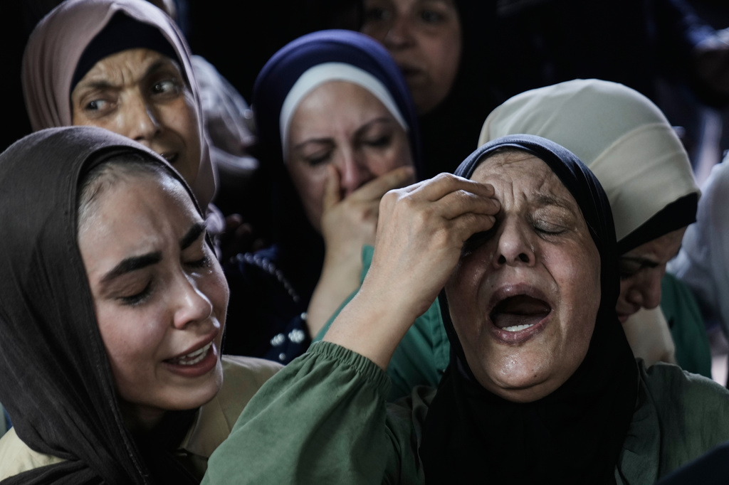 Relatives mourn during the funeral of Islam Ajouri, 14, who, according to the Palestinian Ministry of Health, was killed by Israeli forces, at the hospital in the West Bank city of Nablus, Sunday, Aug. 23, 2026. (AP Photo/Majdi Mohammed)