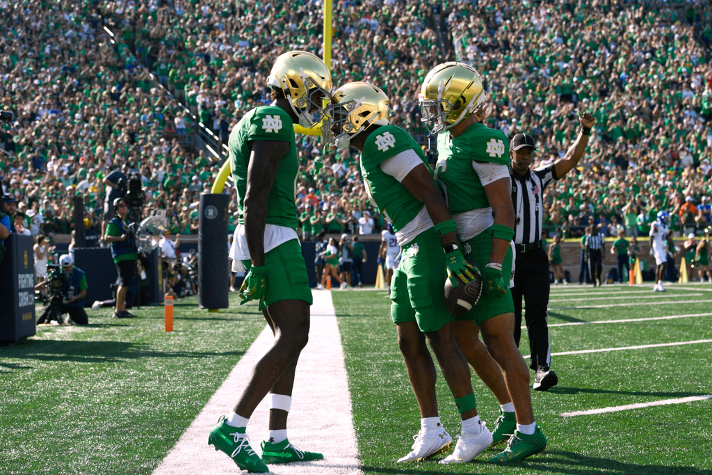 Notre Dame wide receiver Will Pauling (2) celebrates with teammates Malachi Fields, left, and Jordan Faison, right, in the end zone after catching a touchdown pass during the first quarter of an NCAA college football game against Boise St, Saturday, Oct. 4, 2025, in South Bend, Ind. (AP Photo/Paul Beaty)