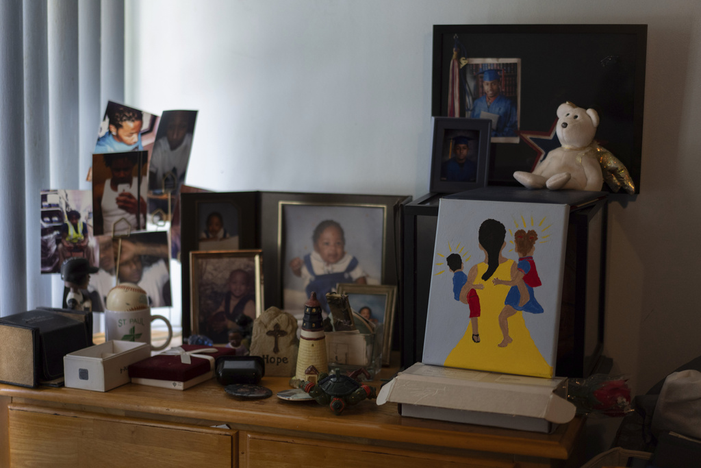 Delphine Cherry's photos of her son, Tyler Randolph, and a painting she made of a mother holding two children sit on a dresser in her home Friday, Sept. 5, 2025, in Hazel Crest, Ill. (AP Photo/Carolyn Kaster)