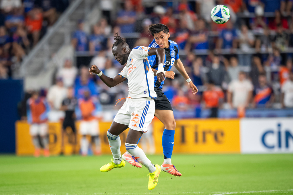 FC Cincinnati forward Kei Kamara, left, heads a ball as CF Montréal defender Fernando Álvarez, right, defends during the second half of an MLS soccer match, Saturday, Oct. 18, 2025, in Cincinnati. (AP Photo/Tanner Pearson)