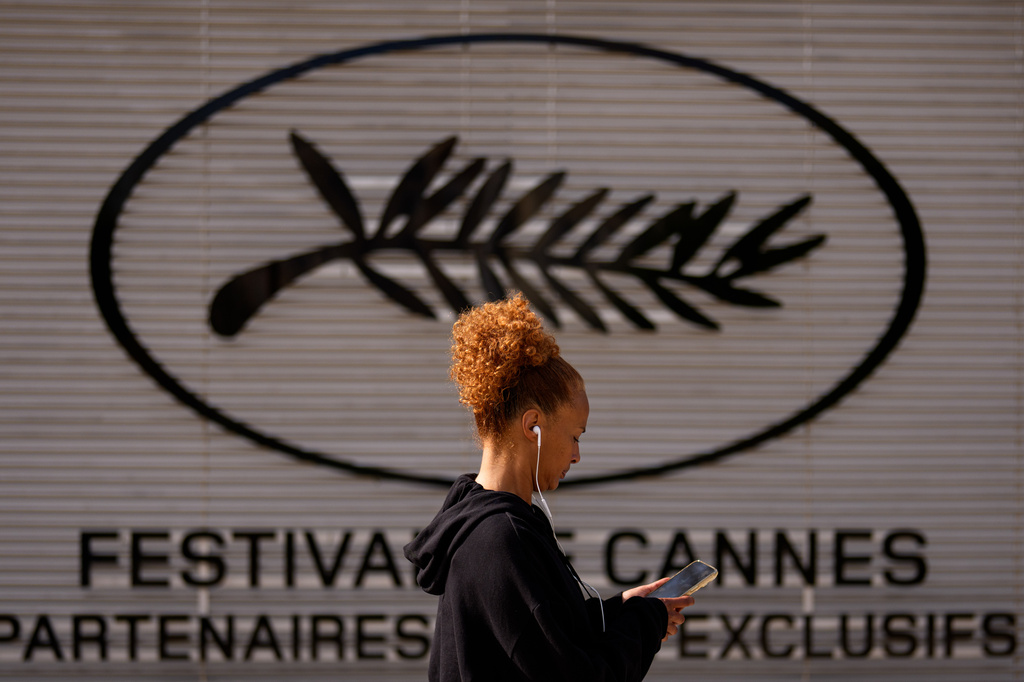 A person walks past the Cannes film festival signage prior to the 79th international film festival, Cannes, southern France, Monday, May 11, 2026. (AP Photo/Andreea Alexandru)