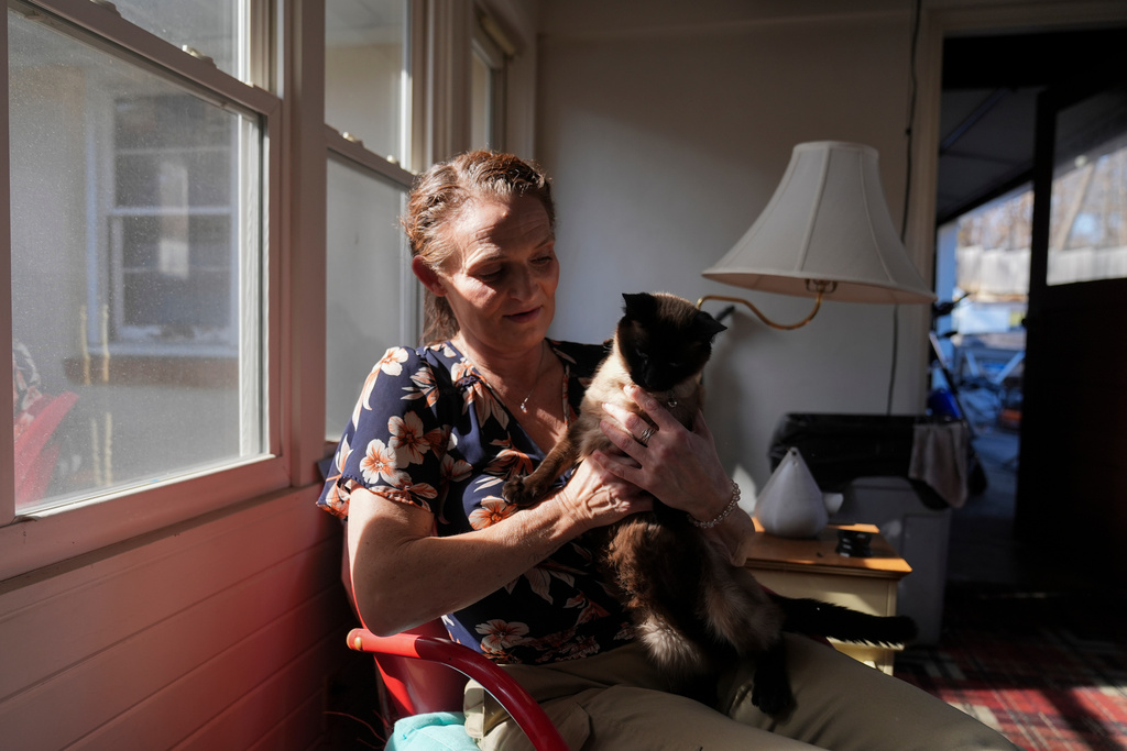 Jessica Thompson, 47, sits for a portrait at her Rockford, Ill., home on Saturday, March 21, 2026. (AP Photo/Erin Hooley)