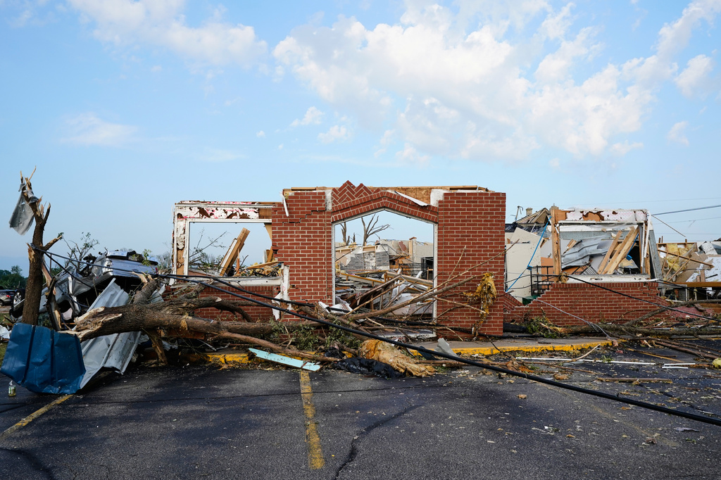 Debris is seen in front of a damaged building after a tornado struck Monday, July 27, 2026, in Menasha, Wis. (AP Photo/Kayla Wolf)