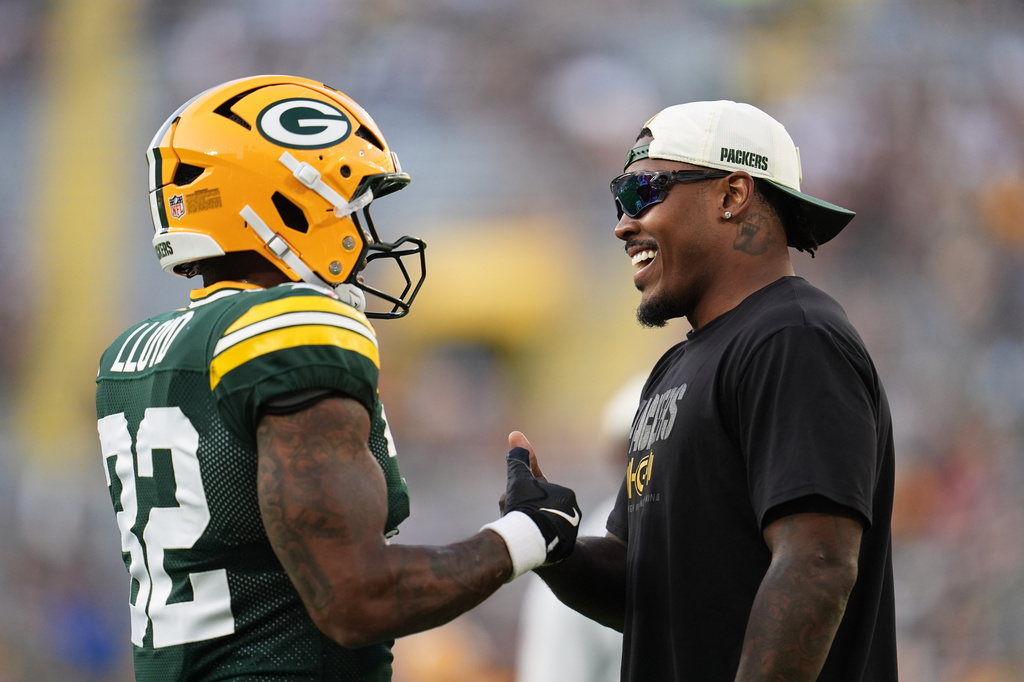 Green Bay Packers' Josh Jacobs talks to Marshawn Lloyd before a preseason NFL football game against the Arizona Cardinals Friday, Aug. 28, 2026, in Green Bay, Wis. (AP Photo/Abbie Parr)