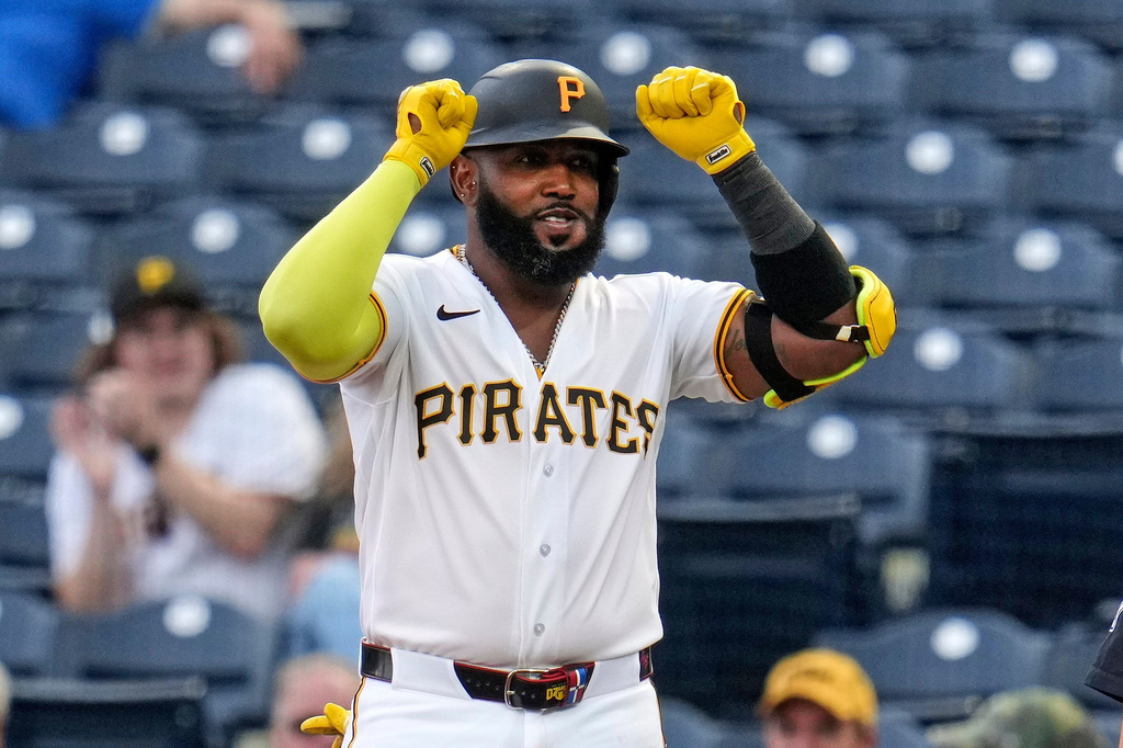 Pittsburgh Pirates' Marcell Ozuna celebrates as he stands on first base after driving in a run with a single off Washington Nationals pitcher Jake Irvin during the first inning of a baseball game in Pittsburgh, Wednesday, April 15, 2026. (AP Photo/Gene J. Puskar)