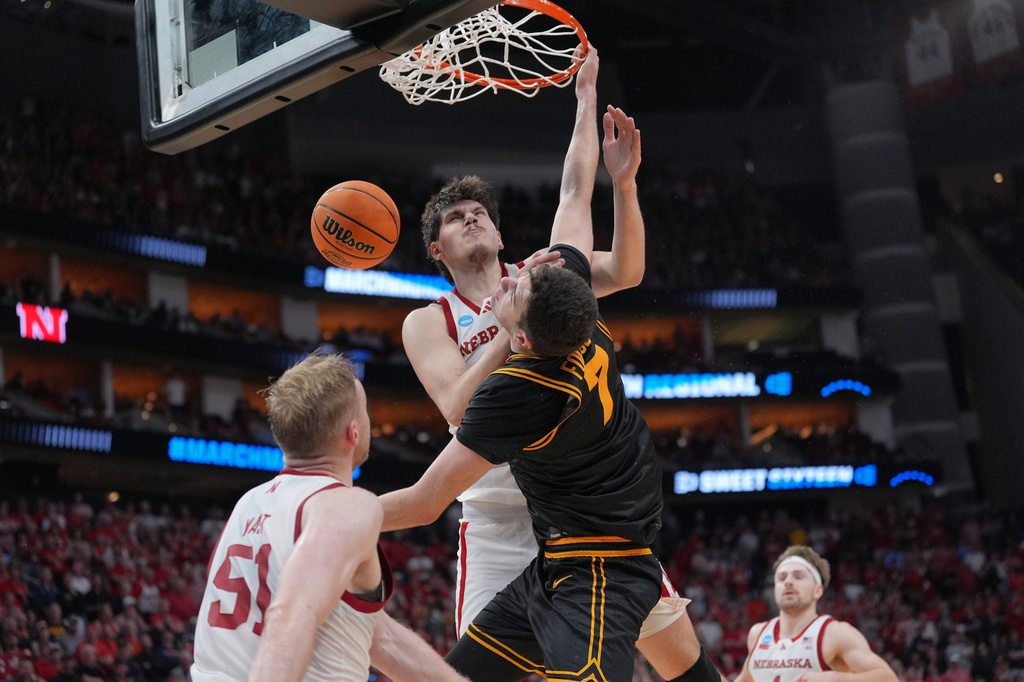 Iowa forward Alvaro Folgueiras (7) dunks over Nebraska forward Berke Buyuktuncel (9) during the second half in the Sweet 16 of the NCAA college basketball tournament Thursday, March 26, 2026, in Houston. (AP Photo/Eric Gay)