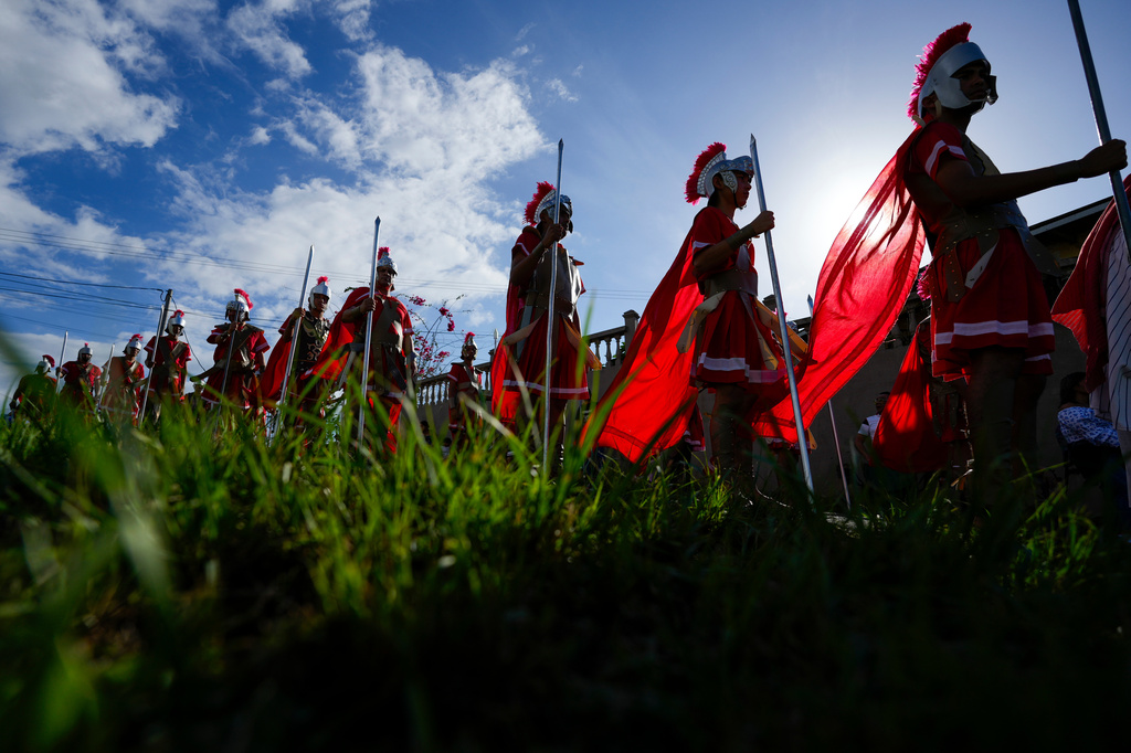 Devotees dressed as Roman soldiers perform in a Way of the Cross reenactment in Arraijan, Panama, Good Friday, April 3, 2026. (AP Photo/Matias Delacroix)