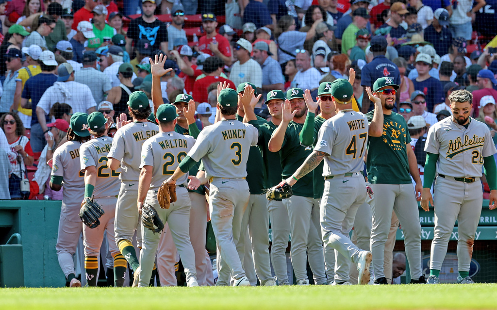 The Athletics celebrate their win over the Boston Red Sox at the end of a baseball game against the Boston Red Sox, Sunday, Aug. 9, 2026, in Boston. (AP Photo/Mark Stockwell)