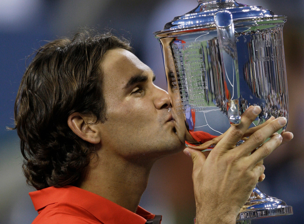 FILE - Roger Federer, of Switzerland, kisses the championship trophy after winning the men's finals championship over Andy Murray, of Britain, at the U.S. Open tennis tournament in New York, Monday, Sept. 8, 2008. (AP Photo/Charles Krupa, File)