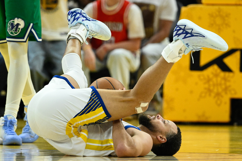 Golden State Warriors guard Stephen Curry reacts after getting fouled by the Dallas Mavericks during the first half of an NBA basketball game, Thursday, Dec. 25, 2025, in San Francisco. (AP Photo/Eakin Howard)