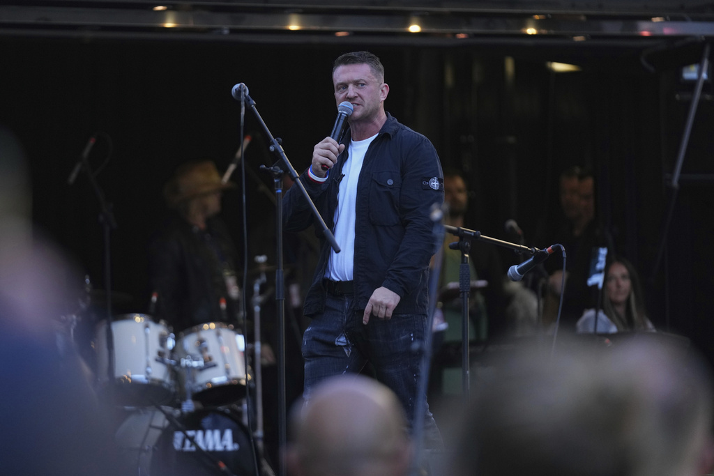 Tommy Robinson speaks during the Unite the Kingdom march and rally near Westminster, London, Saturday Sept. 13, 2025. (AP Photo/Joanna Chan)