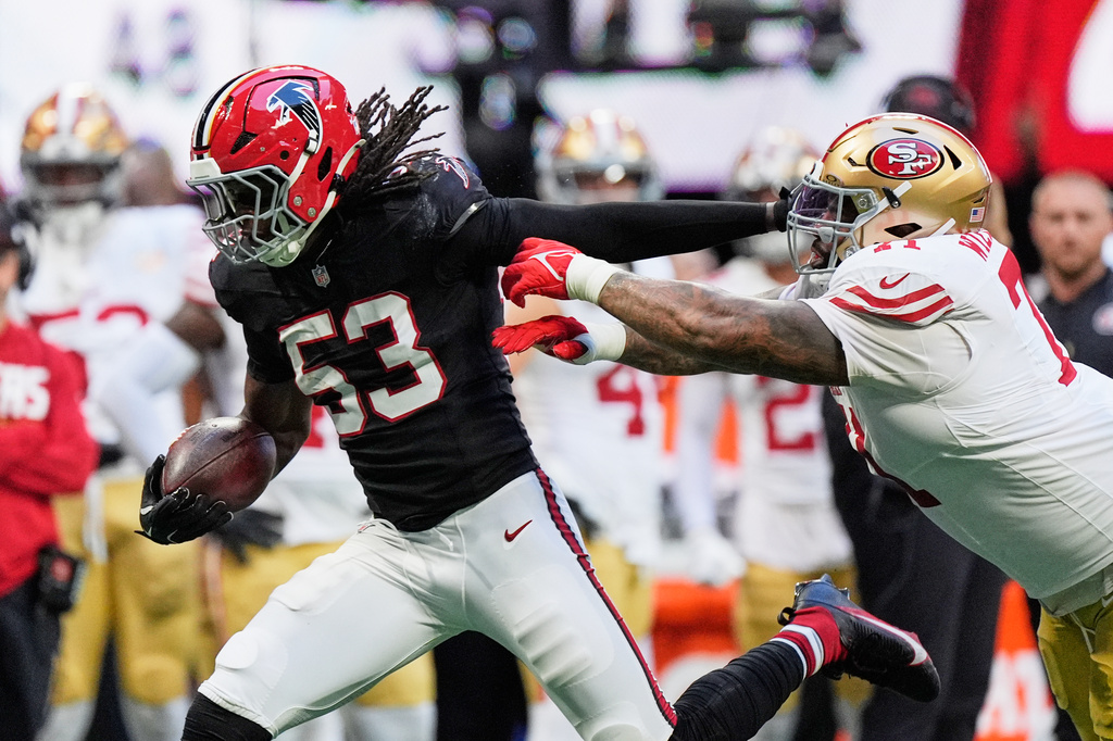 Atlanta Falcons linebacker Kendal Daniels (53) returns an interception as San Francisco 49ers offensive tackle Trent Williams, right, makes the stop during the second half of an NFL football game in Atlanta, Sunday, Oct. 25, 2026. (AP Photo/Mike Stewart)