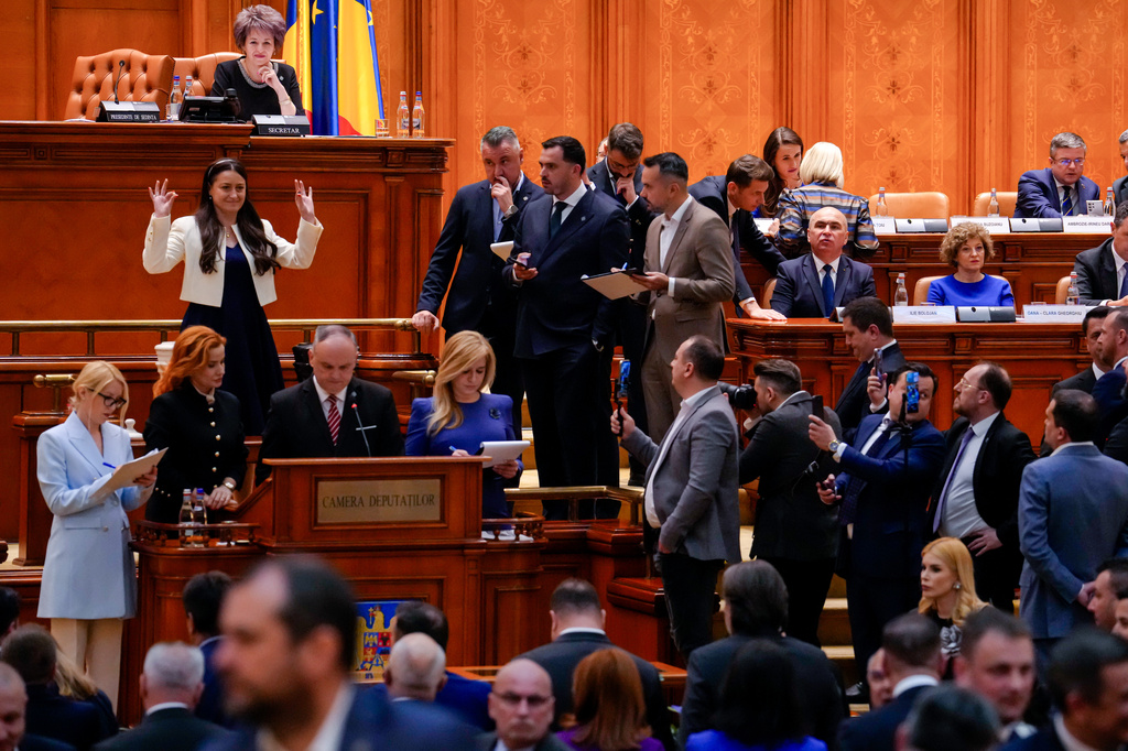 Romanian Prime Minister Ilie Bolojan, centre row third from right, sits as lawmakers vote during a no confidence vote in Bucharest, Romania, Tuesday, May 5, 2026. (AP Photo/Vadim Ghirda)
