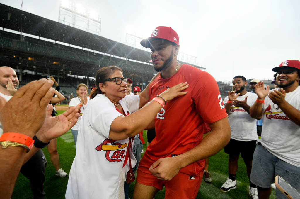 St. Louis Cardinals' Joshua Baez, right, gets a hug from his mother Yris Carmen Baez after defeating the Chicago Cubs in a baseball game in Chicago, Saturday, Aug. 15, 2026. (AP Photo/Paul Beaty)