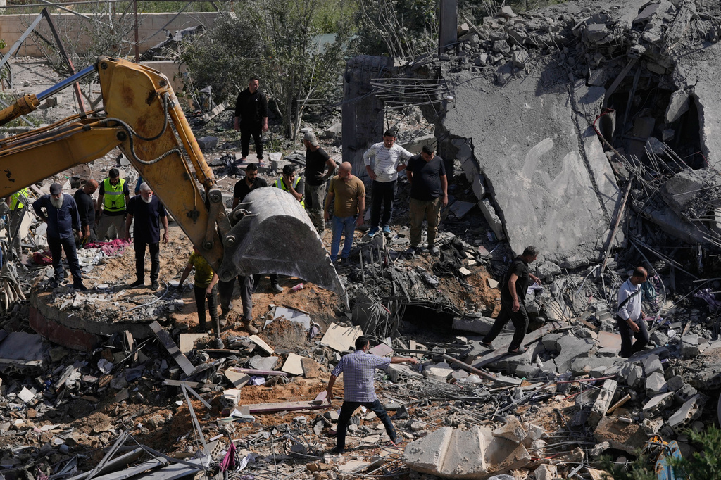 Rescue workers search for survivors using heavy machinery in the rubble of houses damaged by an Israeli airstrike in the village of Saksakieh, south Lebanon, Saturday, May 9, 2026. (AP Photo/Mohammed Zaatari)