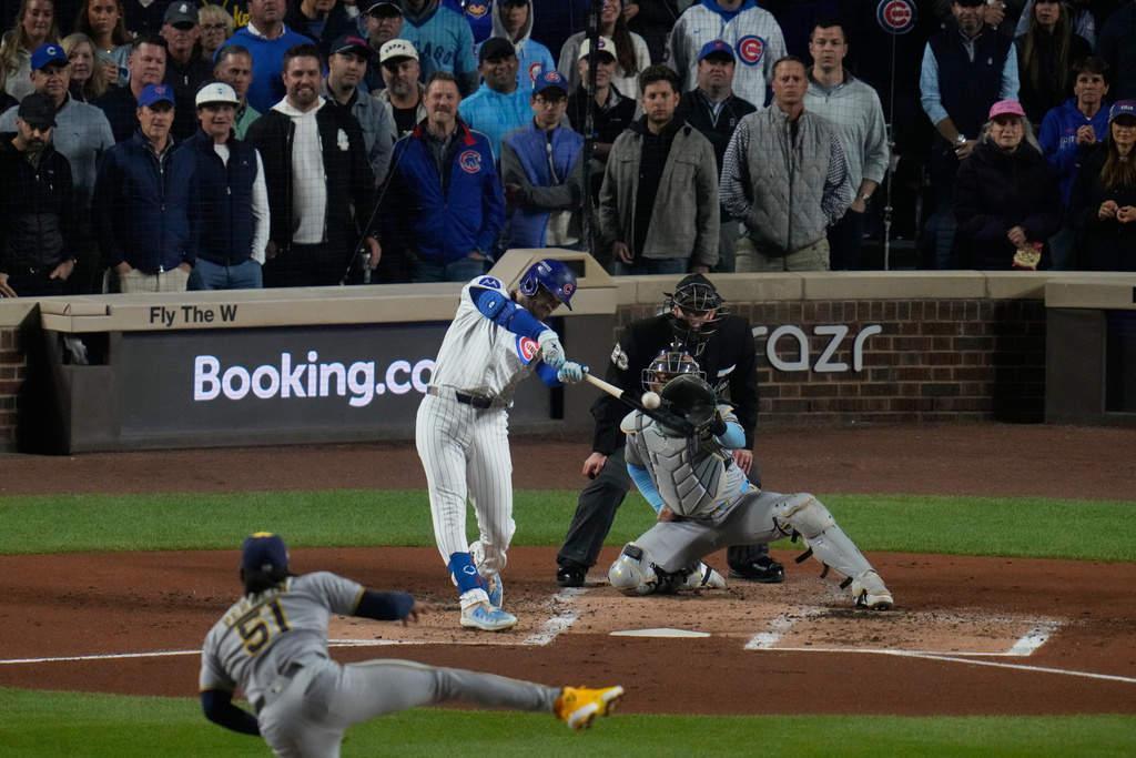 Chicago Cubs' Ian Happ (8) hits a 3-run home run during the first inning of Game 4 of baseball's National League Division Series against the Milwaukee Brewers Thursday, Oct. 9, 2025, in Chicago. (AP Photo/Erin Hooley)