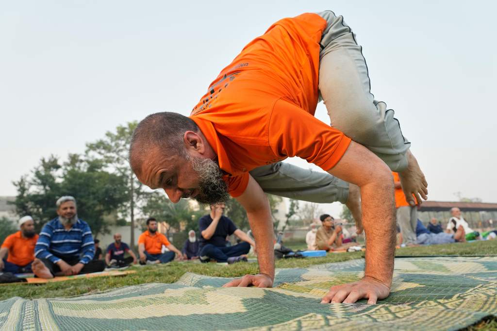 People practice yoga during a celebration of the International Yoga Day in Lahore, Pakistan, Sunday, Jun 21, 2026. (AP Photo/K.M. Chaudary)