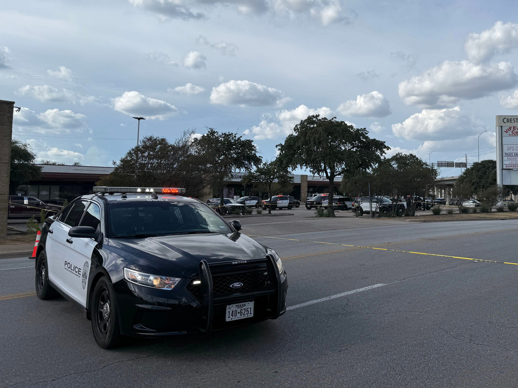 In this photo taken with a smart phone Police block a street after a shooting involving an ICE officer in Austin, Texas, Sunday, Sept. 20, 2026. (AP Photo/Jesse Bedayn)