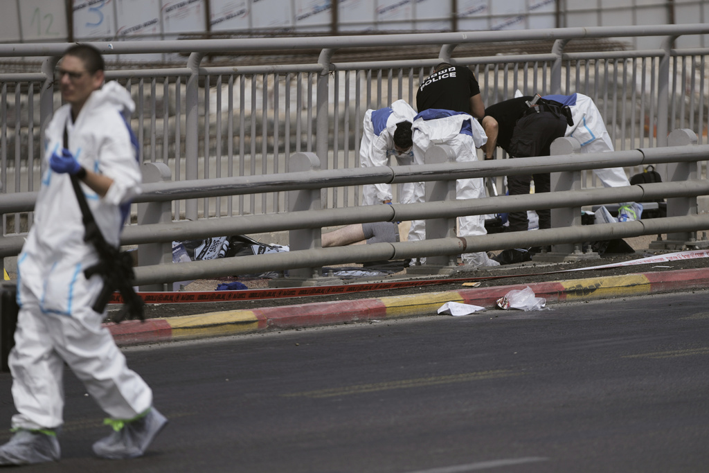 Israeli police and rescue teams respond at the scene of a shooting attack where several people killed and injured in Jerusalem, Monday, Sept. 8, 2025. (AP Photo/Mahmoud Illean)