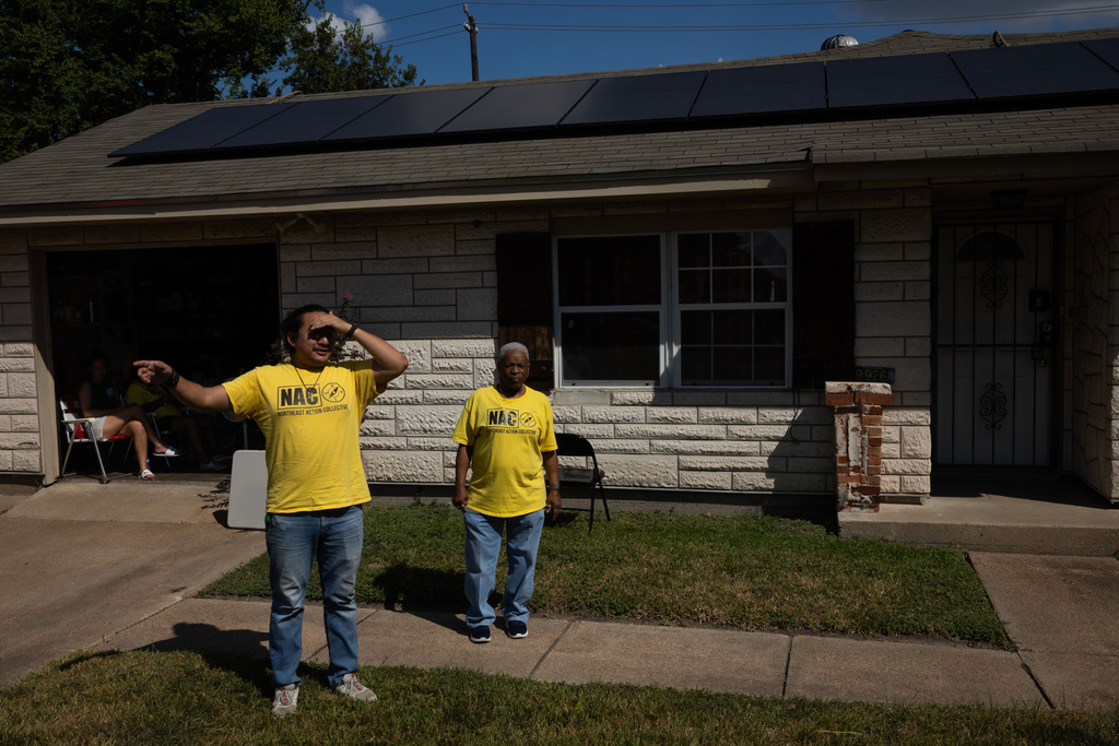 David Espinoza, Hub home captain and co-director of community organizing at West Street Recovery, at left, and Doris Brown, Hub home captain, stand outside Brown's home, Wednesday, Oct. 8, 2025, in Houston. (AP Photo/Antranik Tavitian)