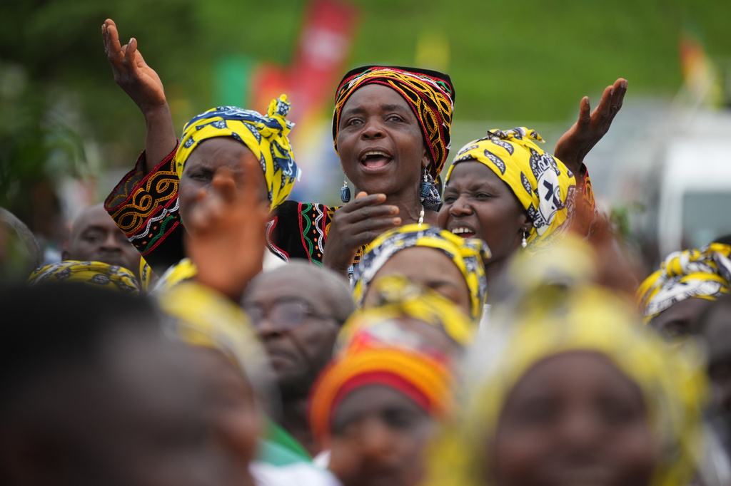 A woman prays during a Mass celebrated by Pope Leo XIV at Bamenda Airport, Cameroon, Thursday, April 16, 2026, on the fourth day of his 11-day pastoral visit to Africa. (AP Photo/Andrew Medichini)