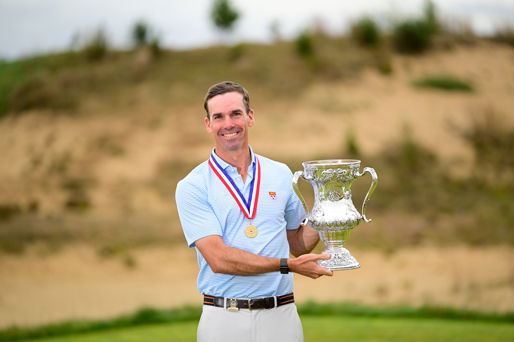 In this photo provided by USGA , Andrew Bailey holds the Robert T. Jones Jr. Memorial Trophy after winning the championship at the 2026 U.S. Mid-Amateur at Sand Valley Resort (The Lido) in Nekoosa, Wis. on Thursday, Oct. 1, 2026. (Logan Whitton/USGA via AP).