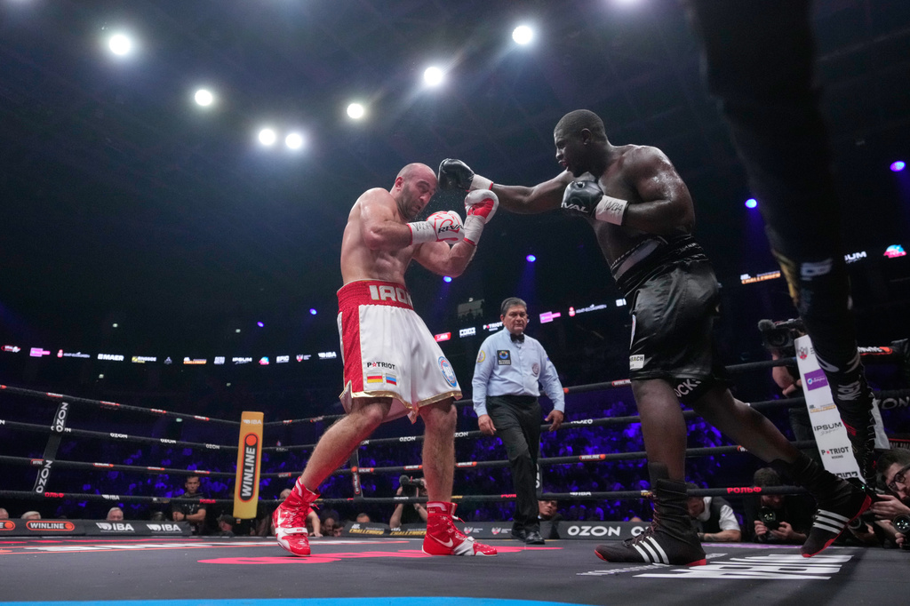 Germany's Peter Kadiru, right, lands a punch on Russia's Murat Gassiev during a WBA Heavyweight world title boxing match as part of the IBA Pro 19 event in Moscow, Russia, Saturday, July. 11, 2026. (AP Photo/Pavel Bednyakov)