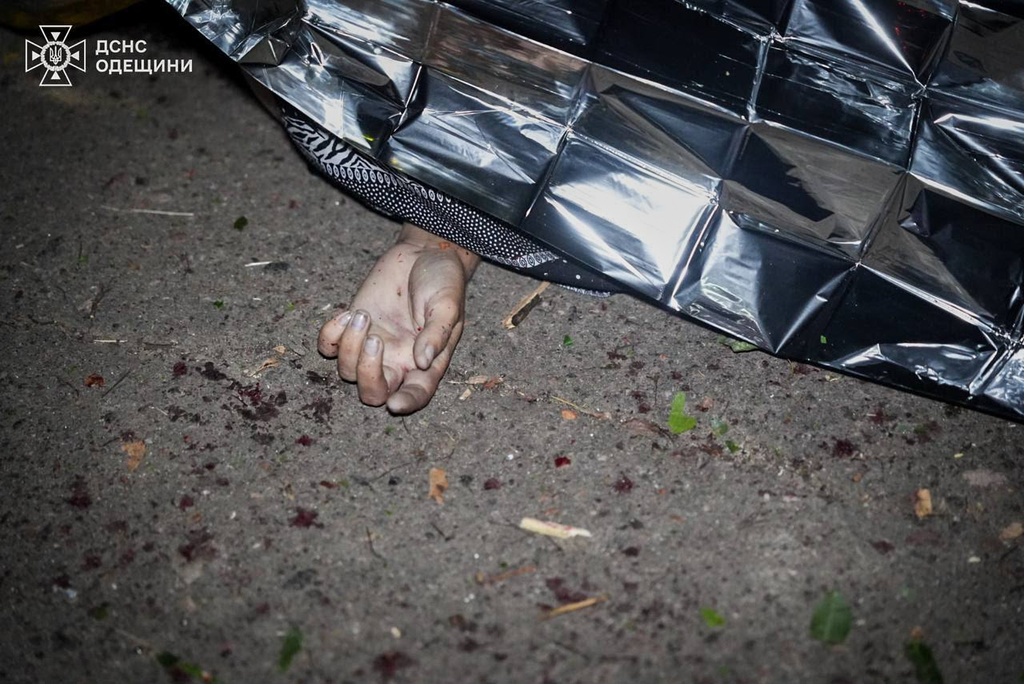 In this photo provided by the Ukrainian Emergency Service, a body of a local resident is covered after a Russian missile attack in center of Odesa, Ukraine, Friday, July 17, 2026. (Ukrainian Emergency Service via AP)