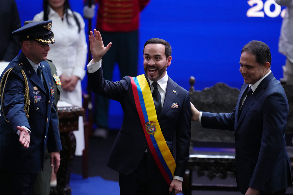 Colombia's President Abelardo de la Espriella waves after receiving the presidential sash from Senate President Honorio Henriquez during his inauguration in Cali, Colombia, Friday, Aug. 7, 2026. (AP Photo/Matias Delacroix)