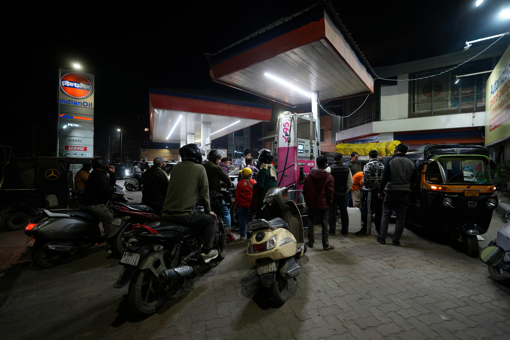 FILE - Motorists wait to get fuel at a pump, fearing a possible fuel shortage due to the US Iran war, in Srinagar, Indian controlled Kashmir, Wednesday, March 25, 2026. (AP Photo/Mukhtar Khan, file)