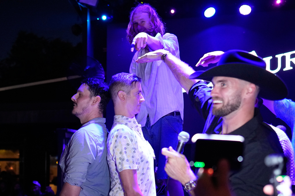 Carter Blab, left, and Weston Borghesi, stand back-to-back to see who is the tallest man attending a Tall Tour event Saturday, May 9, 2026, in Austin, Texas. (AP Photo/David J. Phillip)