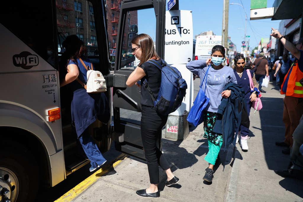 Commuters board buses to Long Island outside of the Jamaica–179th Street station as Long Island Rail Road workers enter the third day of their strike, Monday, May 18, 2026, in New York. (AP Photo/Heather Khalifa)