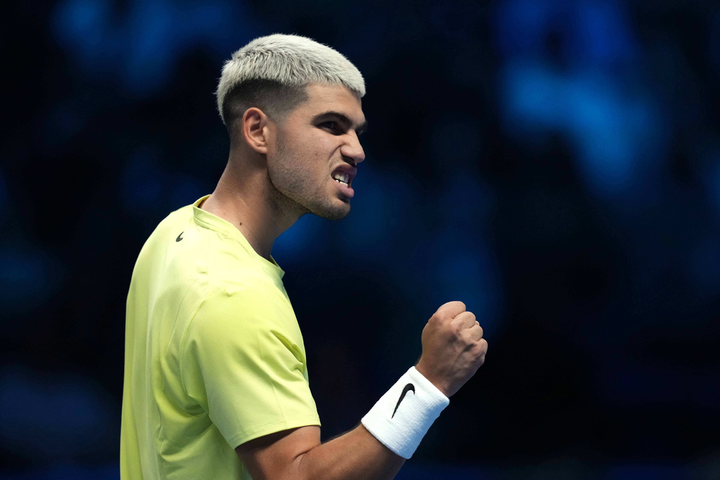 Spain's Carlos Alcaraz reacts after winning a point against Australia's Alex de Minaur during their singles tennis match of the ATP World Tour Finals, in Turin, Italy, Sunday, Nov. 9, 2025. (AP Photo/Antonio Calanni)