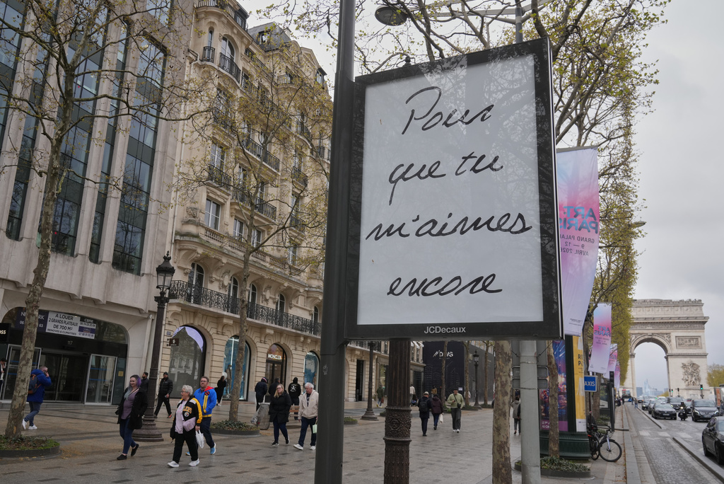 A poster featuring the French title of Céline Dion's song "If That's What It Takes," promoting autumn concerts in France on the Champs-Élysées in Paris, Wednesday, March 25, 2026. (AP Photo/Michel Euler)