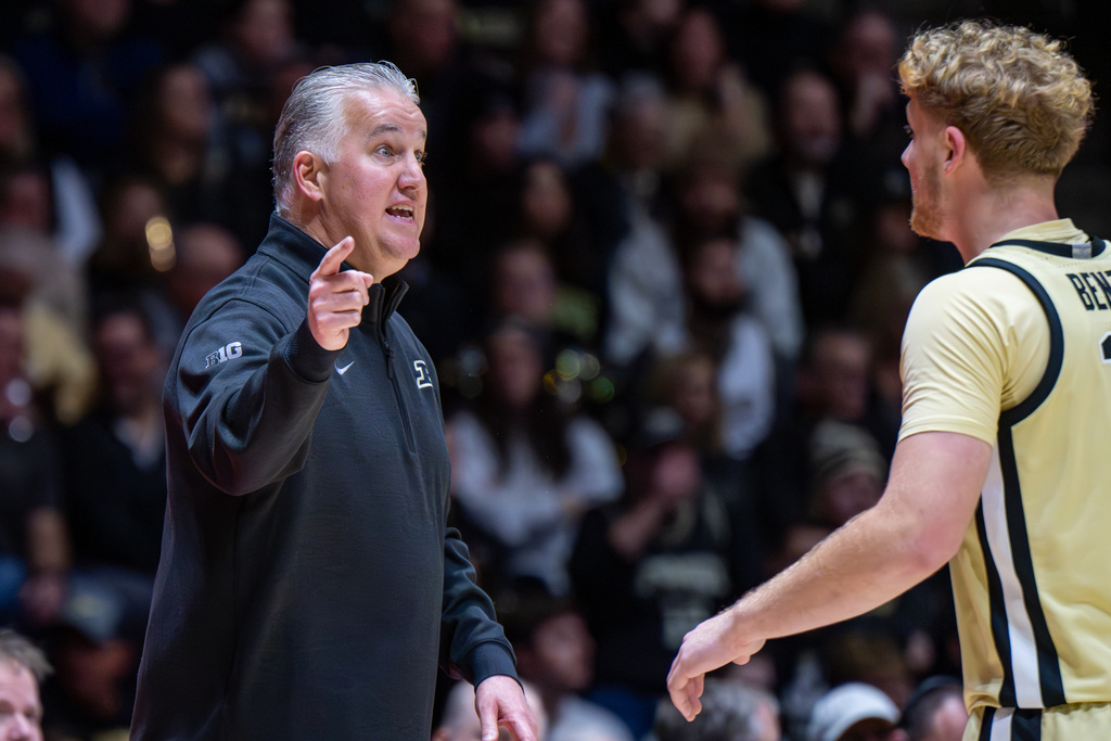 Purdue head coach Matt Painter talks with guard Jack Benter during a break in the first half of an NCAA college basketball game against Kent State, Monday, Dec. 29, 2025, in West Lafayette, Ind. (AP Photo/Doug McSchooler)