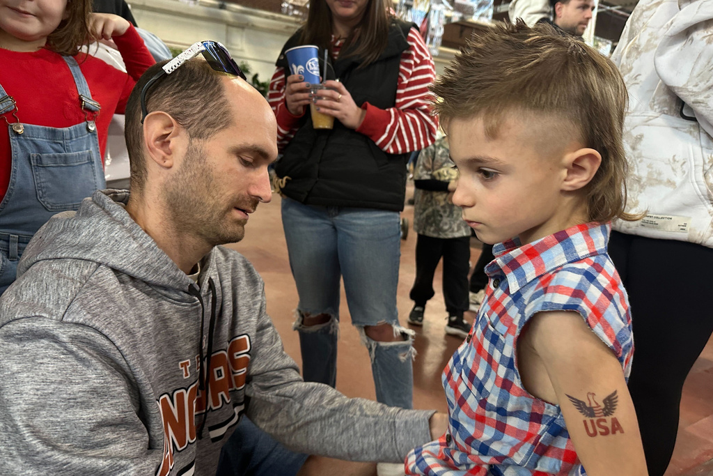 Billy Jenkins, left, gets his 6-year-old son Axell Jenkins ready for a mullet hairstyle contest, Monday, Jan. 12, 2026 in Harrisburg, Pa. (AP Photo/Tassanee Vejpongsa)