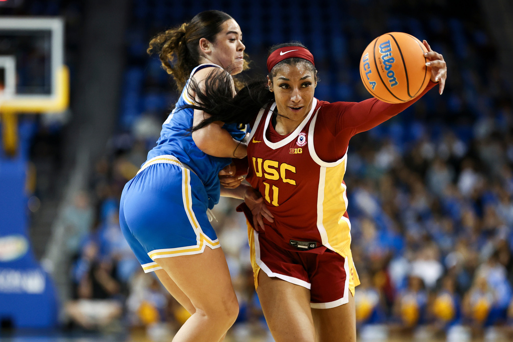 Southern California guard Kennedy Smith (11) drives against UCLA guard Charlisse Leger-Walker, left, during the first half of an NCAA college basketball game, Saturday, Jan. 3, 2026, in Los Angeles. (AP Photo/Jessie Alcheh)