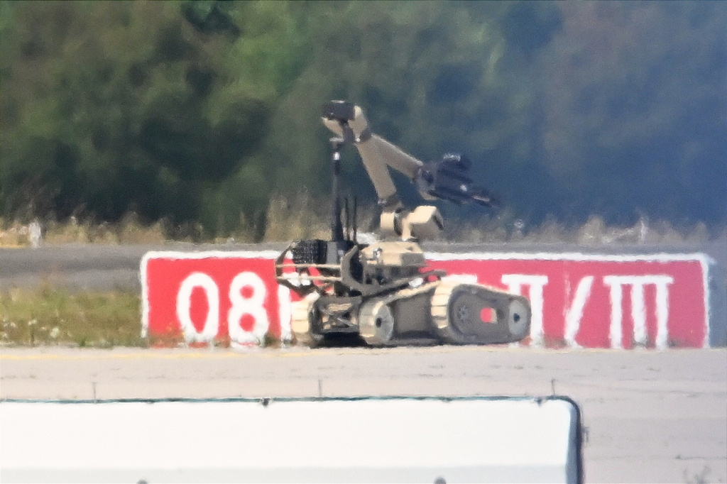 A bomb-disposal robot is being deployed near a Ukrainian aircraft at Leipzig/Halle Airport, in Schkeuditz, Germany, Wednesday Aug. 5, 2026, where flight operations were suspended overnight after a drone sighting was reported and another object was found near a runway. (Hendrik Schmidt/dpa via AP)
