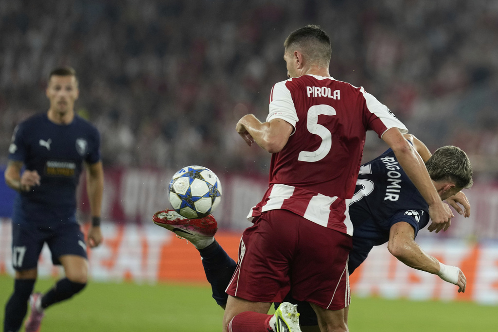 Pafos' Vlad Dragomir fights for the ball against Pafos' David Goldar during a Champions League opening phase soccer match between Olympiakos and Pafos at the Georgios Karaiskakis stadium, Piraeus port, near Athens, Greece, Wednesday, Sept. 17, 2025. (AP Photo/Petros Giannakouris)