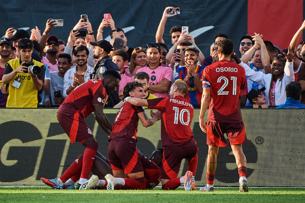 Toronto FC's Djordje Mihailovic (10) celebrates with Theo Corbeanu (7) after a goal against Inter Miami during the second half of a MLS soccer game, Saturday, Sept. 27, 2025, in Toronto. (Sammy Kogan/The Canadian Press via AP)