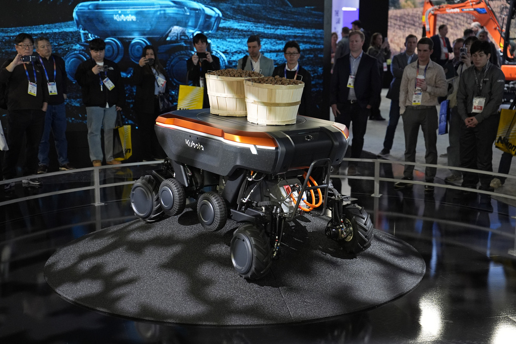 People view a demonstration of the KATR robot designed to work in agriculture and construction at the Kubota booth during the CES tech show Tuesday, Jan. 7, 2025, in Las Vegas. (AP Photo/John Locher)