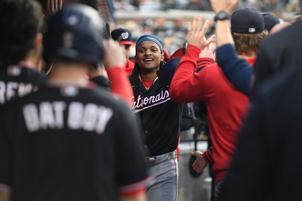 Washington Nationals' CJ Abrams, middle, is congratulated after hitting a home run during the first inning of a baseball game against the Detroit Tigers, Tuesday, Sept. 22, 2026, in Detroit. (AP Photo/Jose Juarez)