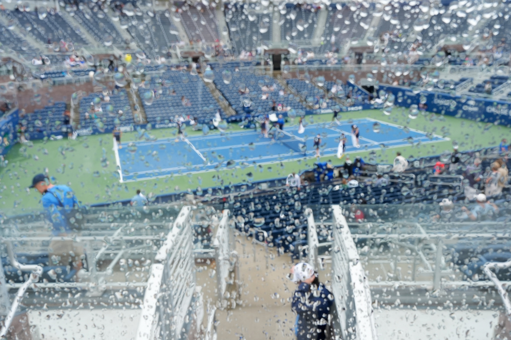 Rain drops are visible on a glass at the Grandstand stadium during the U.S. Open tennis championships Wednesday, Sept. 2, 2026, in New York. (AP Photo/Seth Wenig)
