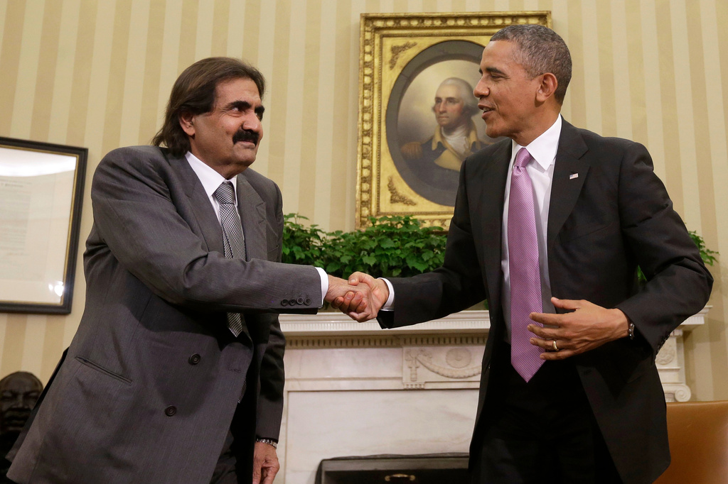 FILE - President Barack Obama shakes hands with Sheikh Hamad bin Khalifa Al Thani of Qatar during their meeting in the Oval Office of the White House in Washington, April 23, 2013. (AP Photo/Pablo Martinez Monsivais, File)