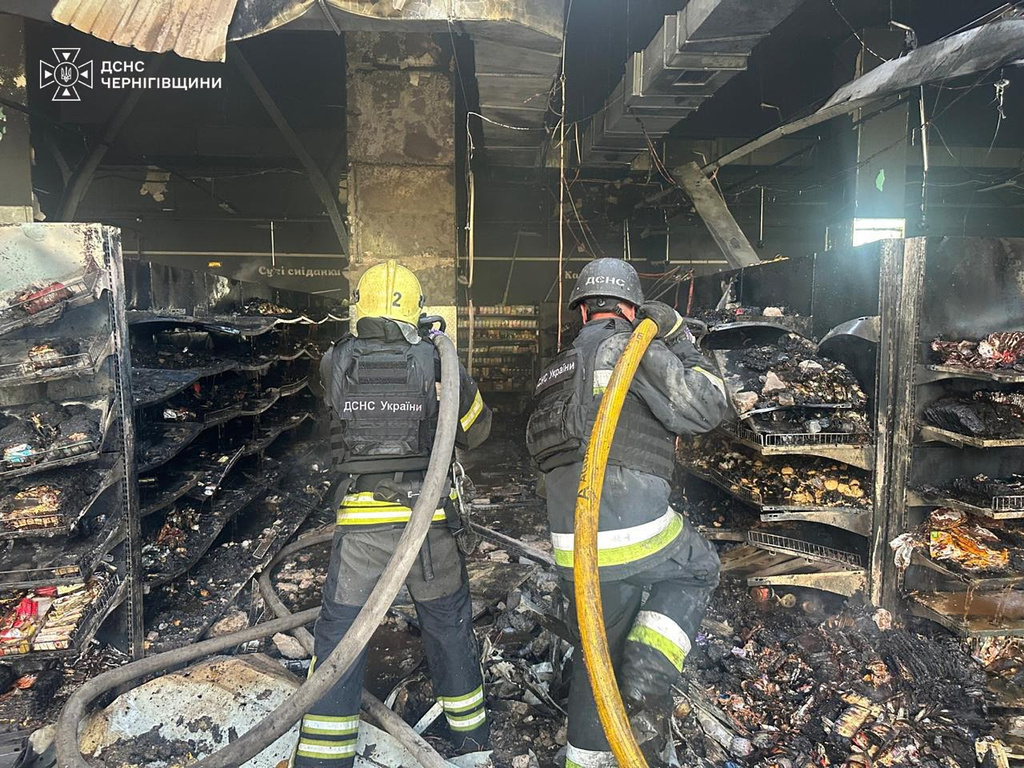 In this photo provided by the Ukrainian Emergency Service, firefighters put out a fire in a supermarket following a Russian drone attack in Chernihiv, Ukraine, Sunday, July 26, 2026. (Ukrainian Emergency Service via AP)