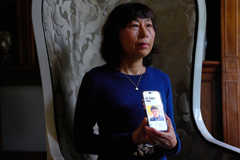 Yufang Rong, wife of U.S. citizen Youlin Chen, who she says has been wrongfully detained in China, holds a photograph of him as seen on a website about detainees on her phone, during an interview, Tuesday, Sept. 22, 2026, in Washington. (AP Photo/Jacquelyn Martin)